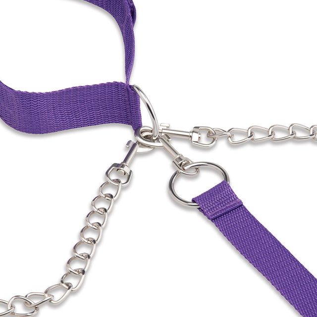 Close-up of a purple strap with silver chain and hardware on a white background